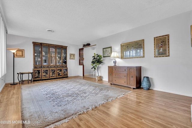 648 E Bayview Ave, Ocean Gate, NJ 08740 - living area featuring wood finished floors and a textured ceiling