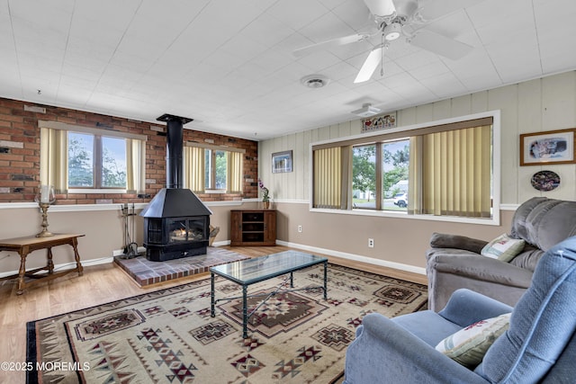 648 E Bayview Ave, Ocean Gate, NJ 08740 - living area featuring a wood stove, wood finished floors, and ceiling fan