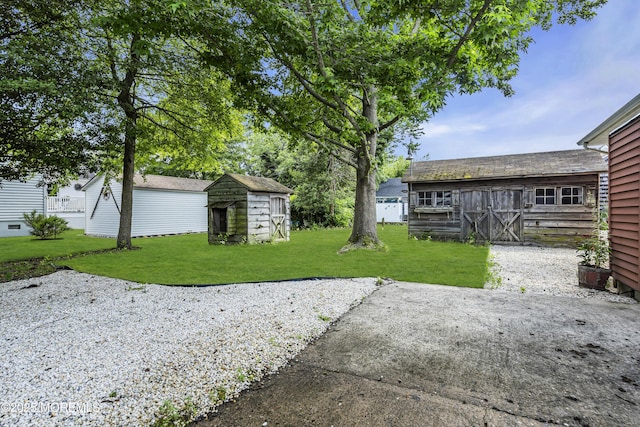 648 E Bayview Ave, Ocean Gate, NJ 08740 - view of grassy yard featuring a shed and a barn
