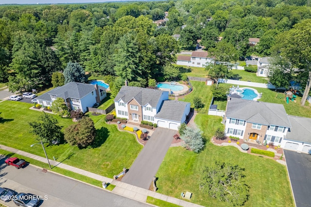 18 Rowena Rd, Manalapan, NJ 07726 - drone / aerial view of a pool area and a heavily wooded area