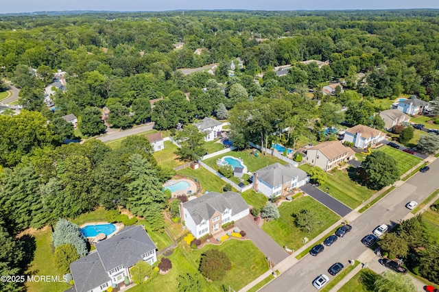 18 Rowena Rd, Manalapan, NJ 07726 - aerial view of a pool area and a heavily wooded area