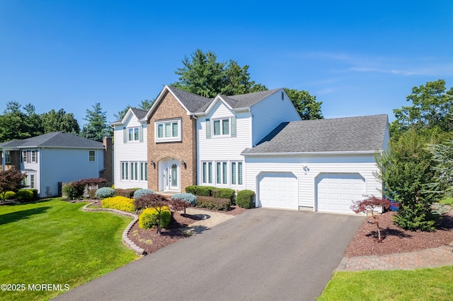 18 Rowena Rd, Manalapan, NJ 07726 - view of front of home with a garage, asphalt driveway, and a front yard