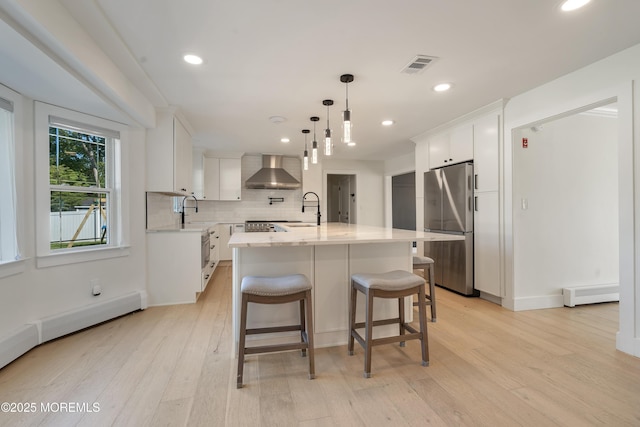 18 Rowena Rd, Manalapan, NJ 07726 - kitchen with freestanding refrigerator, wall chimney range hood, white cabinets, backsplash, and light wood-type flooring