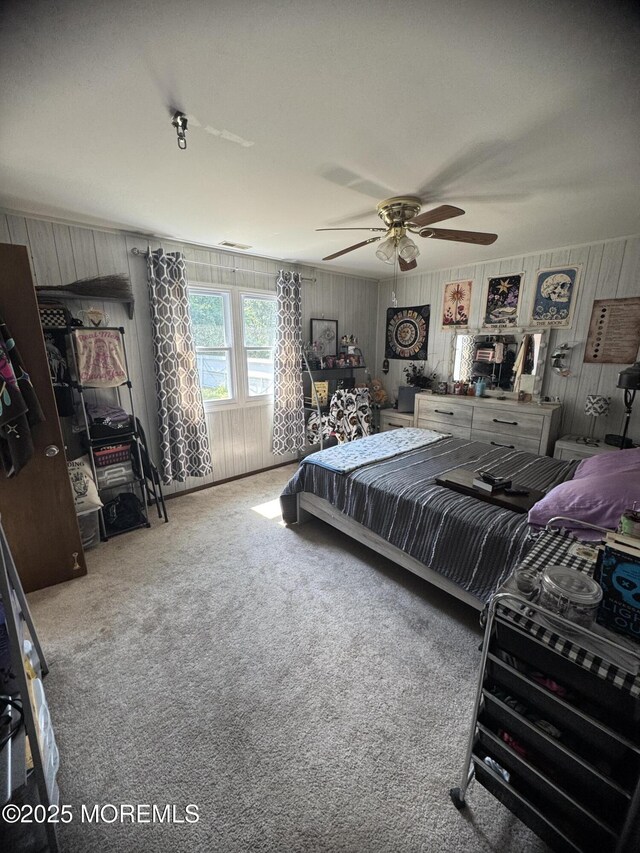 9 Winnebago Trl, Browns Mills, NJ 08015 - carpeted bedroom featuring wooden walls and ceiling fan