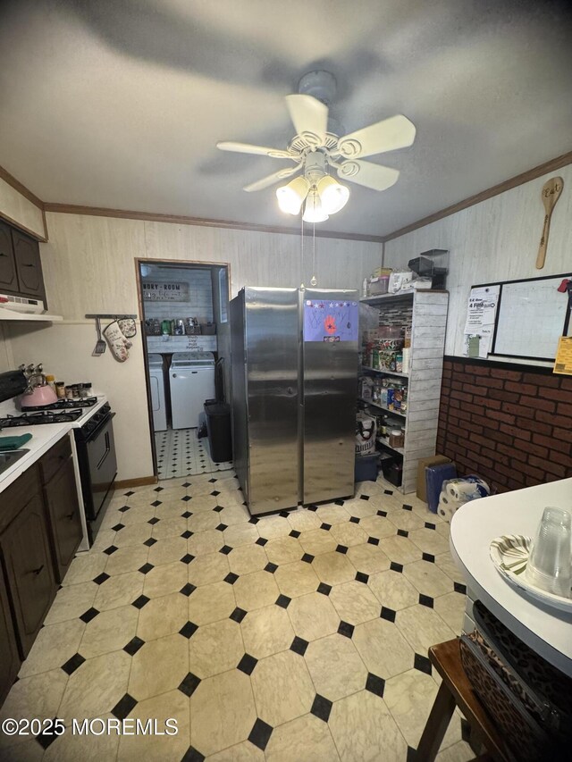 9 Winnebago Trl, Browns Mills, NJ 08015 - kitchen with freestanding refrigerator, ornamental molding, light floors, wooden walls, and black gas range