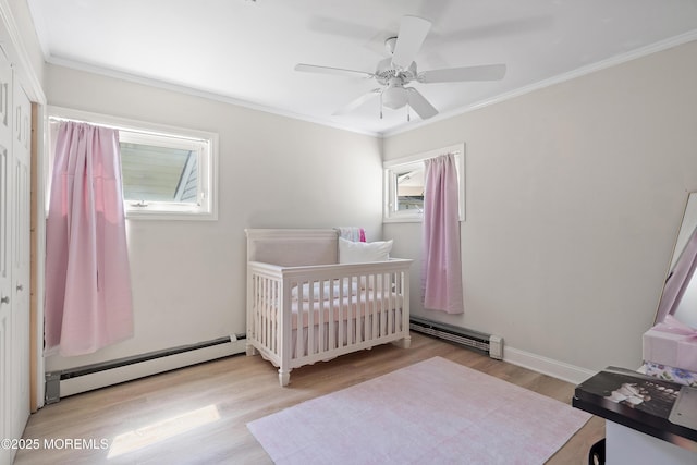 2905 Appleby Dr, Ocean Twp, NJ 07712 - bedroom with baseboard heating, wood finished floors, ornamental molding, and a ceiling fan