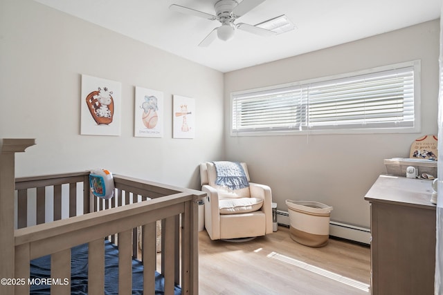 2905 Appleby Dr, Ocean Twp, NJ 07712 - bedroom with light wood-style floors, a crib, baseboard heating, and ceiling fan