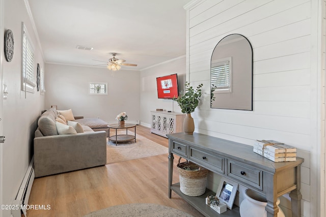2905 Appleby Dr, Ocean Twp, NJ 07712 - living room featuring a baseboard radiator, ceiling fan, light wood finished floors, plenty of natural light, and crown molding
