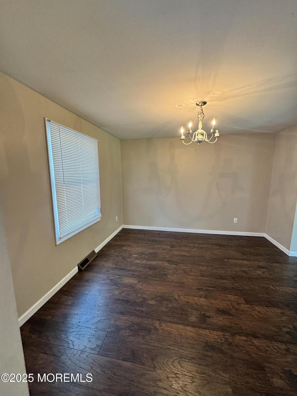 353 Pfister Rd, Jackson, NJ 08527 - empty room with a chandelier and wood finished floors