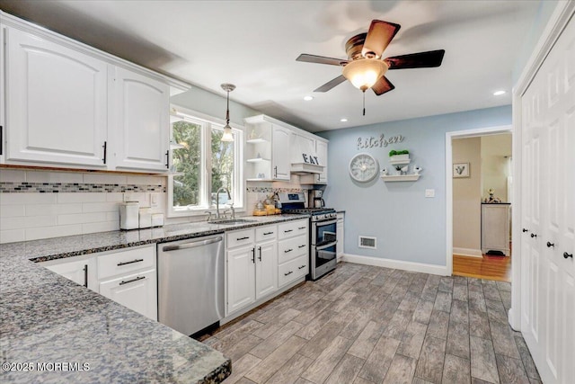 48 Crest Dr, Brick, NJ 08724 - kitchen with appliances with stainless steel finishes, decorative backsplash, white cabinetry, ceiling fan, and dark stone countertops