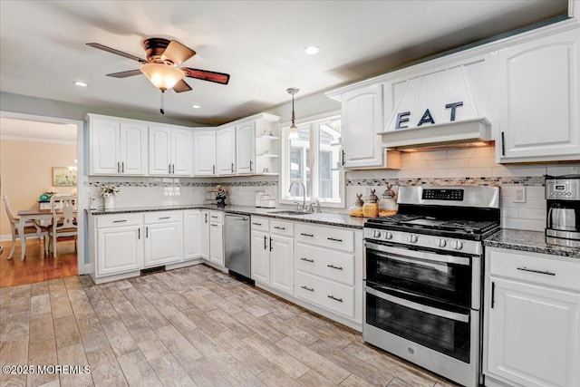48 Crest Dr, Brick, NJ 08724 - kitchen with stainless steel appliances, premium range hood, ceiling fan, dark stone countertops, and backsplash