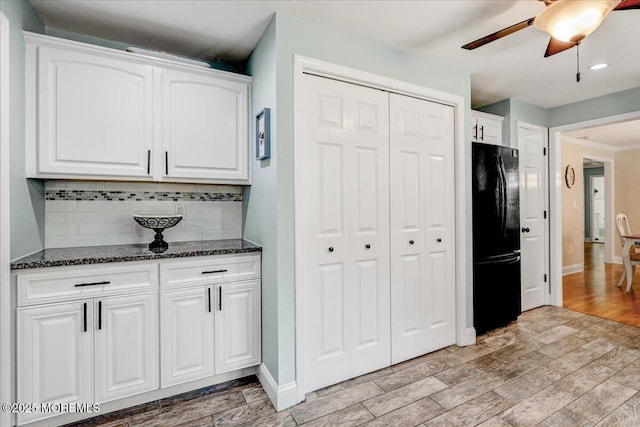 48 Crest Dr, Brick, NJ 08724 - kitchen featuring freestanding refrigerator, tasteful backsplash, white cabinets, dark stone counters, and light wood-style floors