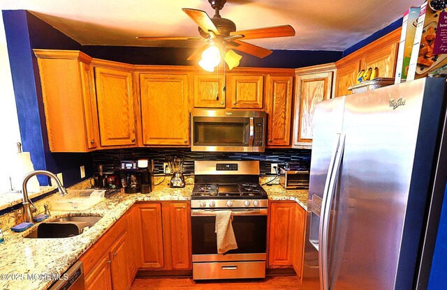 1509 Embury Ave, Neptune Township, NJ 07753 - kitchen featuring appliances with stainless steel finishes, ceiling fan, light stone counters, and tasteful backsplash