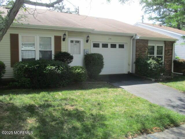 294 Marni Ln, Lakewood, NJ 08701 - single story home with an attached garage, driveway, a front lawn, and brick siding
