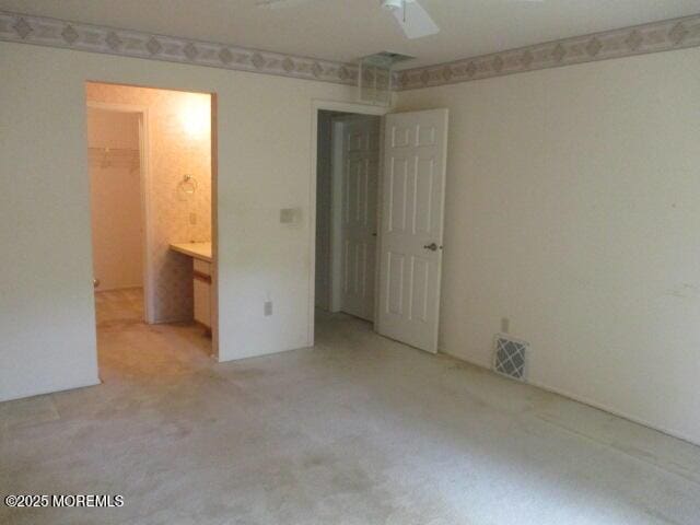 294 Marni Ln, Lakewood, NJ 08701 - unfurnished bedroom with light carpet, a walk in closet, and a ceiling fan