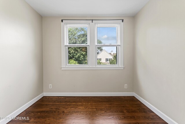 93 Barker Ave, Shrewsbury Twp, NJ 07724 - empty room with dark wood-style flooring and baseboards