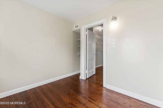 93 Barker Ave, Shrewsbury Twp, NJ 07724 - unfurnished bedroom featuring wood finished floors, a closet, and a spacious closet