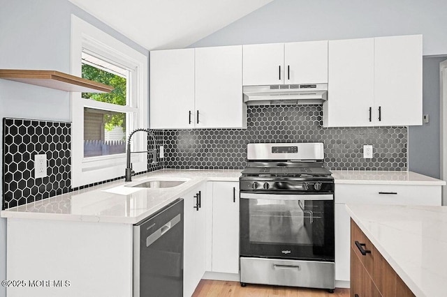 50 Pacific Blvd, Keyport, NJ 07735 - kitchen with appliances with stainless steel finishes, under cabinet range hood, lofted ceiling, light stone counters, and white cabinets