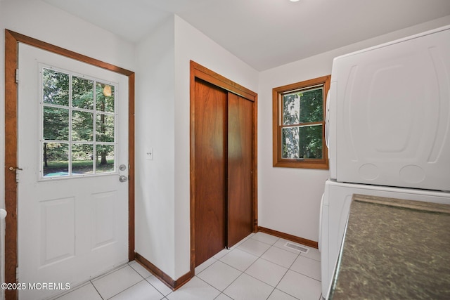 38 Pine St, Lincroft, NJ 07738 - entrance foyer with stacked washer / dryer and light tile patterned flooring