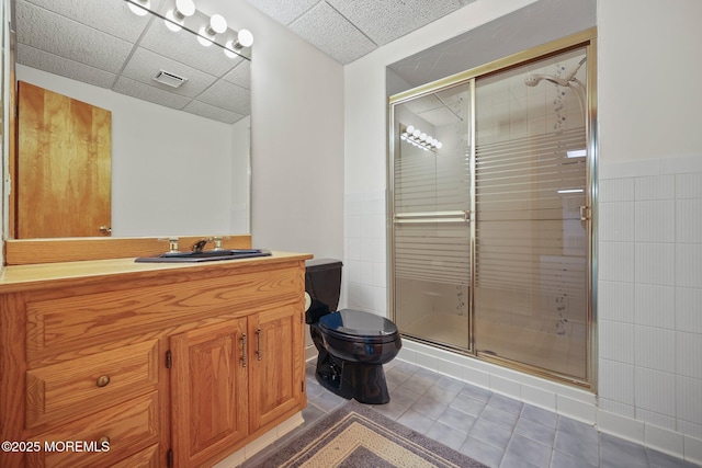 38 Pine St, Lincroft, NJ 07738 - bathroom with a shower stall, vanity, a paneled ceiling, tile patterned floors, and wainscoting