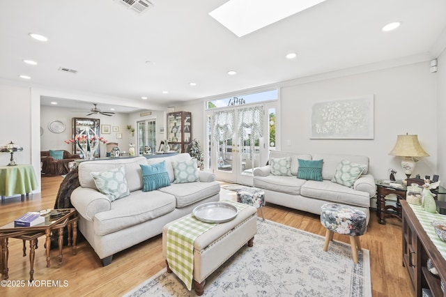 25 Tropicana Ct, Toms River, NJ 08757 - living room featuring ornamental molding, recessed lighting, a skylight, and light wood-style flooring