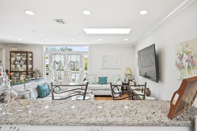 25 Tropicana Ct, Toms River, NJ 08757 - living area with crown molding, a skylight, recessed lighting, french doors, and wood finished floors