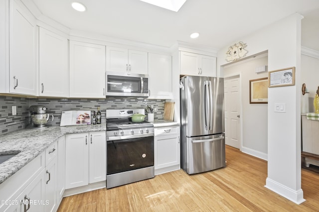25 Tropicana Ct, Toms River, NJ 08757 - kitchen with stainless steel appliances, white cabinets, decorative backsplash, light wood-style flooring, and recessed lighting
