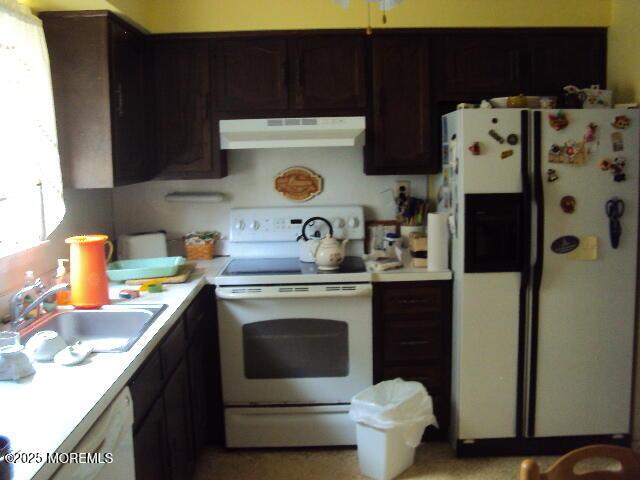 6 Hardy Ct, Brick, NJ 08724 - kitchen with white appliances, exhaust hood, light countertops, and dark brown cabinetry