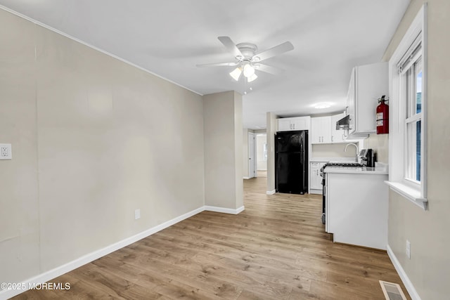 9 Frederick Dr, Bayville, NJ 08721 - kitchen featuring freestanding refrigerator, a ceiling fan, white cabinets, light wood-type flooring, and light countertops