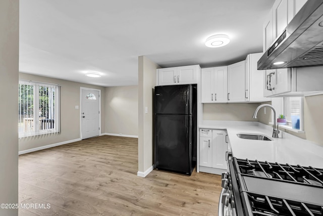9 Frederick Dr, Bayville, NJ 08721 - kitchen featuring freestanding refrigerator, exhaust hood, gas range oven, white cabinets, and light countertops