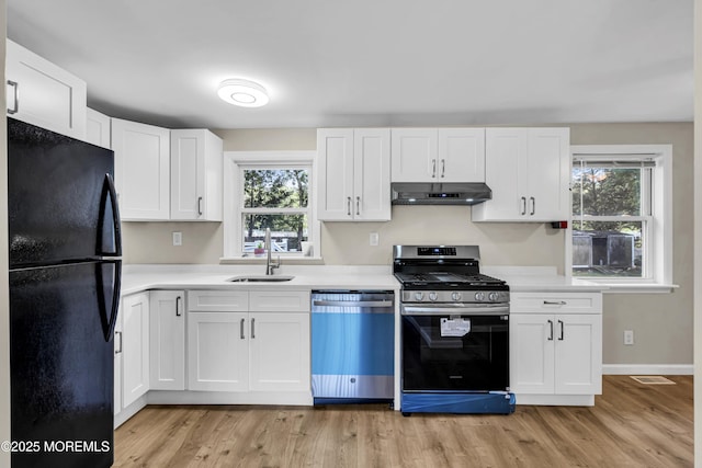9 Frederick Dr, Bayville, NJ 08721 - kitchen with stainless steel appliances, under cabinet range hood, light countertops, light wood-style flooring, and plenty of natural light