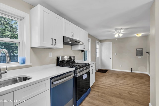 9 Frederick Dr, Bayville, NJ 08721 - kitchen featuring under cabinet range hood, stainless steel gas range oven, dishwasher, light countertops, and white cabinets