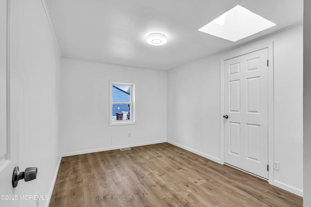 9 Frederick Dr, Bayville, NJ 08721 - spare room with a skylight, wood finished floors, and ornamental molding