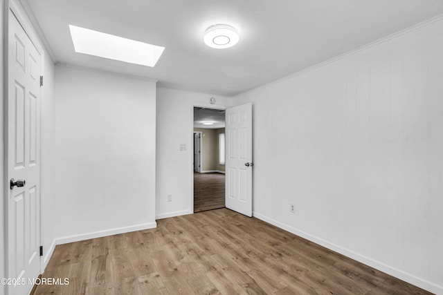 9 Frederick Dr, Bayville, NJ 08721 - unfurnished bedroom featuring a skylight, light wood-type flooring, and crown molding