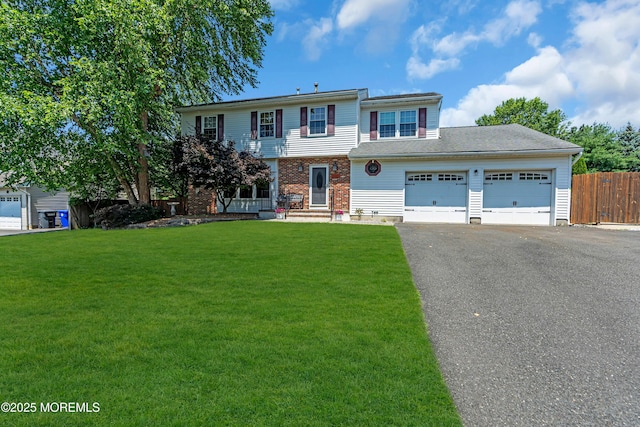 627 Meadow Run, Brick, NJ 08724 - colonial inspired home with asphalt driveway, a garage, and brick siding