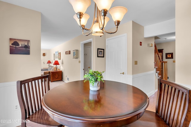627 Meadow Run, Brick, NJ 08724 - dining area with wainscoting, a chandelier, and stairs