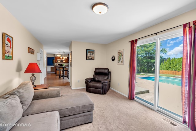 627 Meadow Run, Brick, NJ 08724 - carpeted living room with baseboards and a chandelier