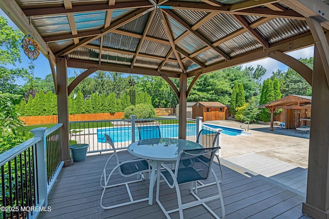 627 Meadow Run, Brick, NJ 08724 - deck with a gazebo, a fenced backyard, a storage unit, and outdoor dining space
