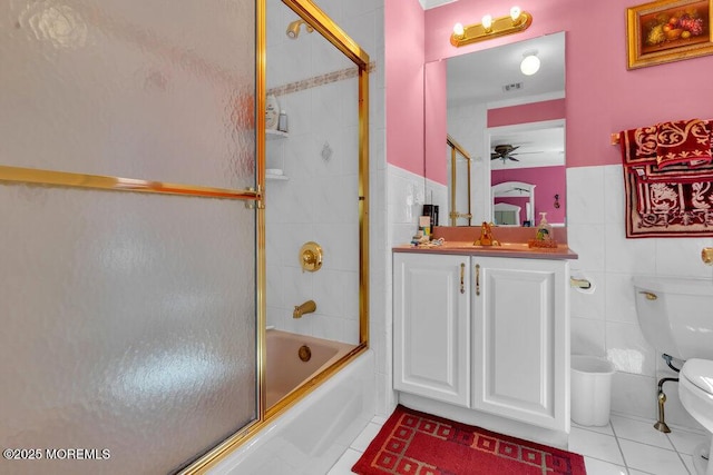 1721 Azure Dr, Wall, NJ 07753 - bathroom with tile patterned flooring, vanity, combined bath / shower with glass door, tile walls, and a wainscoted wall