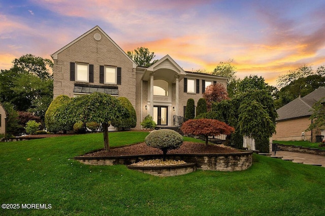 6 Opatut Ct, Morganville, NJ 07751 - view of front facade with french doors, a front yard, and brick siding