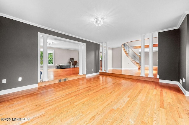6 Opatut Ct, Morganville, NJ 07751 - unfurnished living room featuring ornamental molding, decorative columns, wood finished floors, and stairs