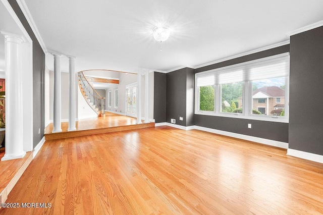 6 Opatut Ct, Morganville, NJ 07751 - unfurnished room featuring ornate columns, ornamental molding, light wood-type flooring, and stairs