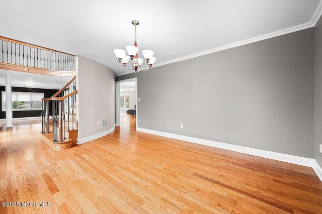 6 Opatut Ct, Morganville, NJ 07751 - empty room featuring light wood-style flooring, healthy amount of natural light, stairway, a chandelier, and ornamental molding