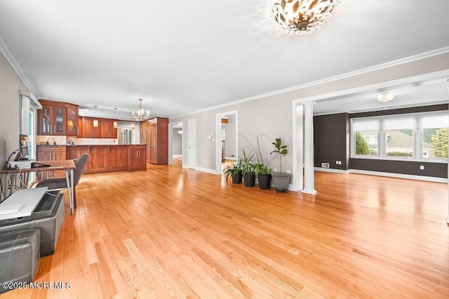 6 Opatut Ct, Morganville, NJ 07751 - living room with a chandelier, crown molding, light wood-type flooring, and decorative columns