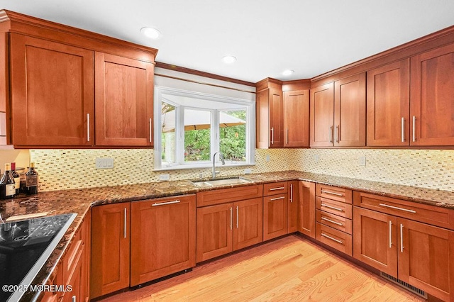 6 Opatut Ct, Morganville, NJ 07751 - kitchen with light wood finished floors, black electric cooktop, backsplash, stone countertops, and recessed lighting
