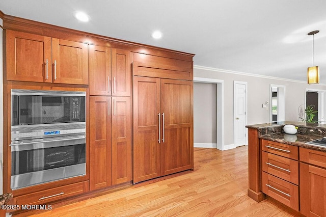 6 Opatut Ct, Morganville, NJ 07751 - kitchen with built in appliances, brown cabinets, dark stone counters, ornamental molding, and light wood-style floors