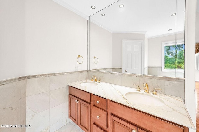 6 Opatut Ct, Morganville, NJ 07751 - bathroom featuring ornamental molding, double vanity, tile walls, wainscoting, and recessed lighting