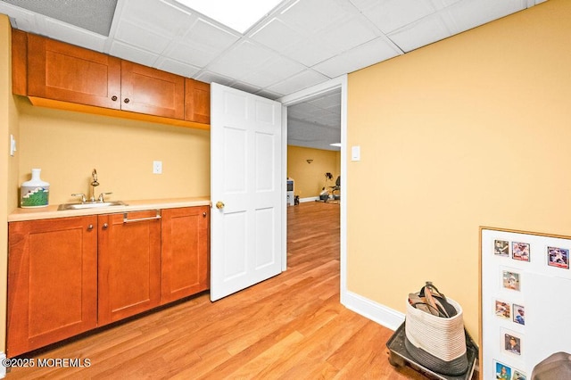 6 Opatut Ct, Morganville, NJ 07751 - kitchen featuring light wood-type flooring, light countertops, and brown cabinetry