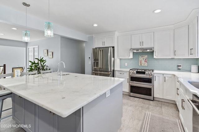 5 Maplecrest Ct, Toms River, NJ 08753 - kitchen featuring appliances with stainless steel finishes, tasteful backsplash, under cabinet range hood, a kitchen breakfast bar, and white cabinetry