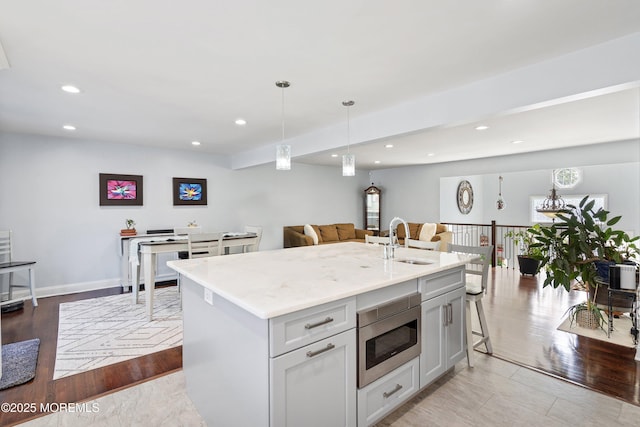 5 Maplecrest Ct, Toms River, NJ 08753 - kitchen featuring stainless steel microwave, open floor plan, recessed lighting, hanging light fixtures, and light stone countertops
